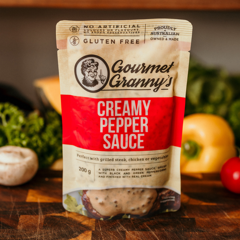 Packaging of Gourmet Granny's Creamy Pepper Sauce with vegetables in the background