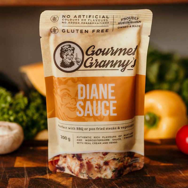 Gourmet Granny Diane Sauce package on a wooden surface with vegetables in the background