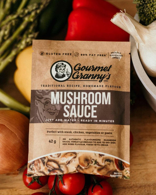 Gourmet Granny's Mushroom Sauce package on a wooden surface with vegetables in the background