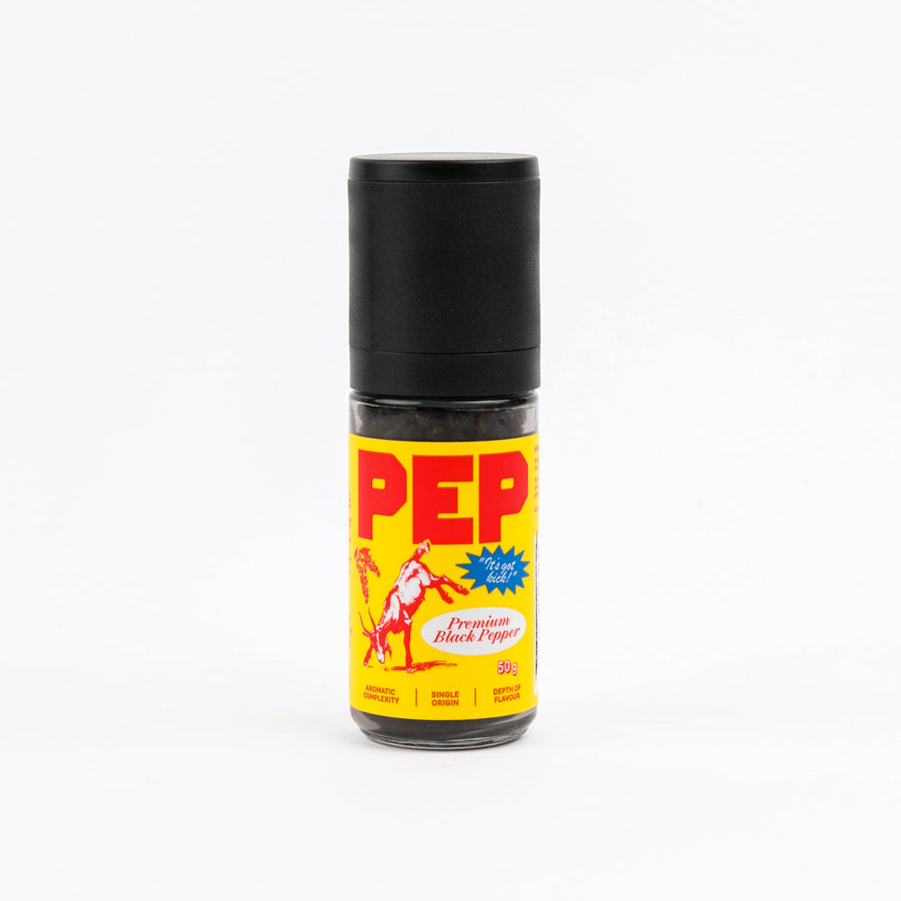 A bottle of PEP Pepper Company Black Pepper, featuring a bright yellow label with red and white lettering and a black cap, set against a plain white background.